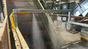 Nebolex spray bar mounted at the end of a conveyor belt for dust suppression